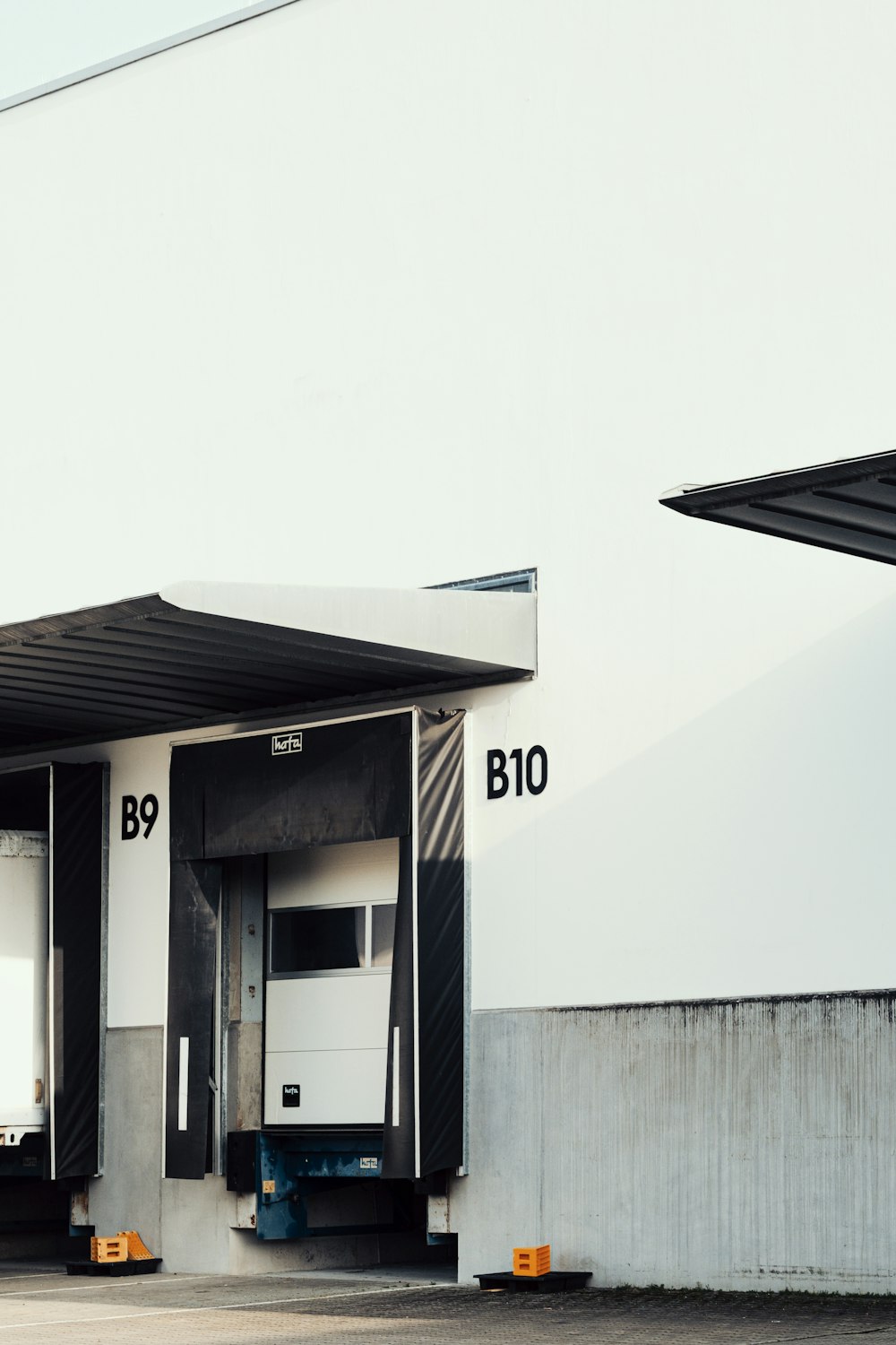 Loading docks B9 and B10 on a pale warehouse wall